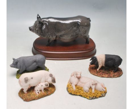 A collection of five ceramic Royal Doulton pigs comprising of of Gloucester Spot, British Saddleback, Vietnamese Pot Belly, L