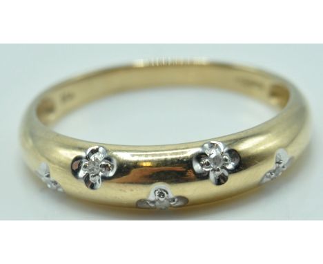 A 9ct gold and diamond ring having five stones set in recessed quatrefoils. Stamped 375. Gross 1.8g. Size P.