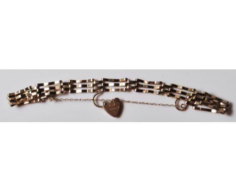 A 9ct gold hallmarked three bar gate chain bracelet, with heart shaped padlock and safety chain. Marked ASJ to the padlock. W