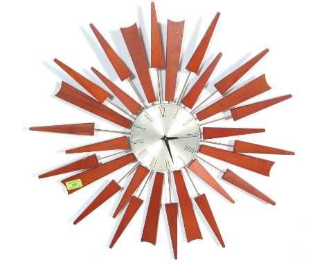 A mid 20th Century retro vintage teak wood and brass sunburst wall clock in the manner of Seth Thomas of Scotland. The starbu