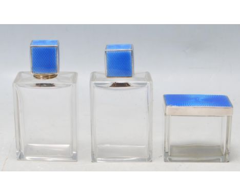 A set of 1930’s Art Deco dressing table items comprising of two silver hallmarked guilloche enamel perfume bottles with silve