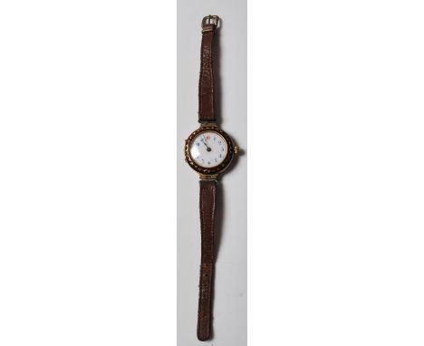 A 20th Century Swiss 9ct gold wrist watch having a round white enamelled face with Arabic numerals to the chapter ring, the c
