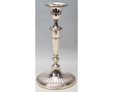 An early 20th century Edwardian silver hallmarked Adam style candlestick having oval sconce and capital tapered column and ov