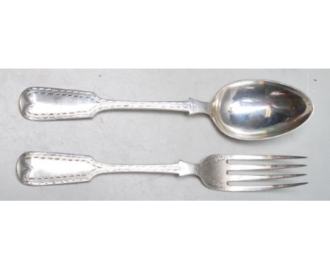 Two 19th Century Victorian John Pope Genge spoon and fork in the fiddle pattern both having engraved borders to the handles. 