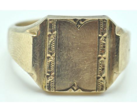 A 9ct gold Birmingham hallmarked signet ring. The ring with an empty square cartouche and decorative border. Assay marked for