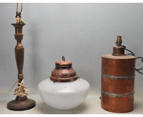 A group of three early 20th century circa 1930’s table lamps and lights to include an Arts and Crafts style copper lamp of a 