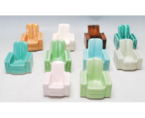 A collection of nine 1930’s Art Deco ceramic pipe rests / stands of various colours in the form of armchairs. B B B makers im