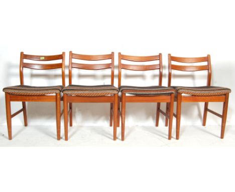 A set of four retro 20th century teak wood dining chairs. The chairs are having show wood frame, padded seats, ladder backres