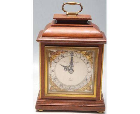 An Edwardian early 20th Century oak cased Elliot mantel clock, retailed by Garrard &amp; Co Ltd, having a signed brass and si