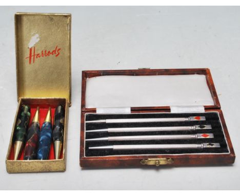 A collection of four vintage stamped sterling silver bridge pens having cuboid tops decorated with playing card suits and in 