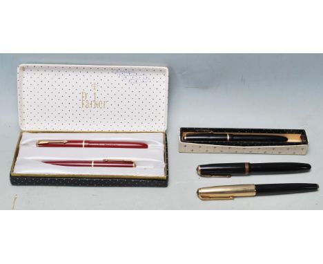 A collection of four vintage late 20th century fountain pens comprising of a boxed Parker slimfold pen pencil set, Boxed Park