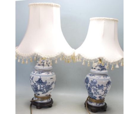 A pair of 20th century antique style Chinese oriental blue and white ginger jar table lamps having brass light fittings, blue