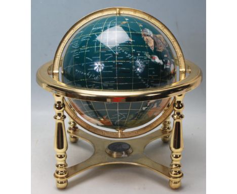 A 20th Century desktop gemstone globe within a brass gimbal stand raised on four turned legs with compass below. Measures 32c