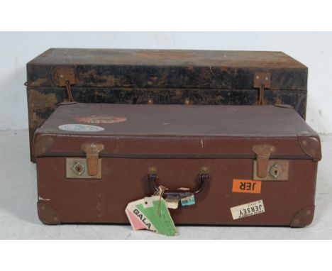 An early 20th century circa 1920’s metal military trunk of a rectangular form having hinged lid painted in black with a notat