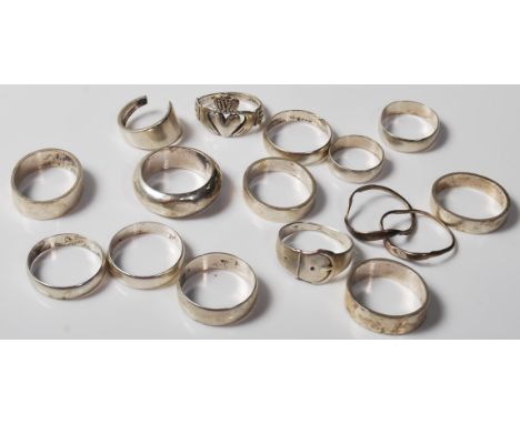 A good collection of silver band and dress rings. To include an Irish silver Claddagh ring, buckle ring, part puzzle ring, ¾ 