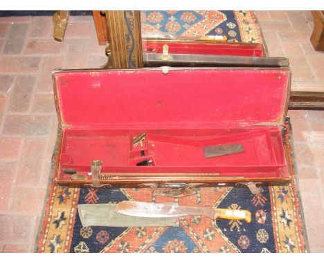 A military machete together with an old leather gun case
