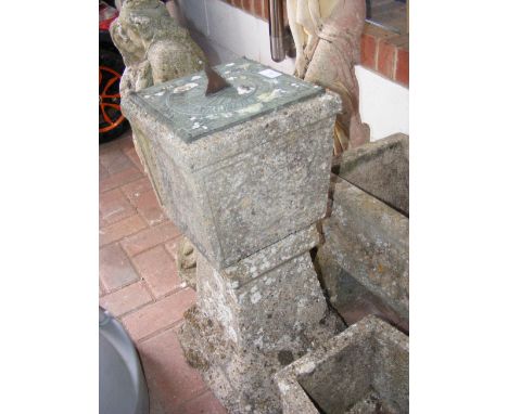 A concrete garden plinth with tempus fugit sundial 