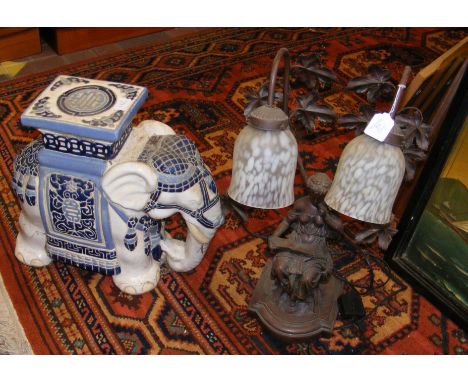 A decorative figural table lamp, together with an elephant garden plant stand
