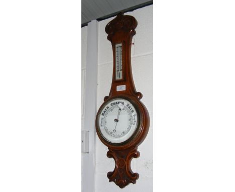 An oak cased barometer and thermometer 
