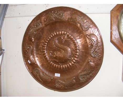 An Arts & Crafts large copper Newlyn style charger embossed with dolphins - 59cm diameter CONDITION REPORT Our team of truste