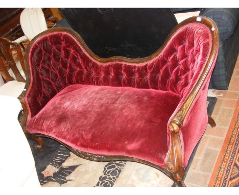 A Victorian double back settee on cabriole supports