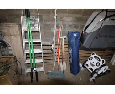 A quantity of long handled tools to include branch lopper, broom, rake, slasher, spades etc.
