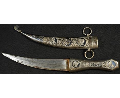 A Middle Eastern silver coloured metal and niello jambiya, 17cm curved blade, the hilt and scabbard decorated with vignettes,