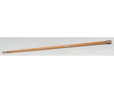 A Victorian gold coloured metal mounted malacca baton or swagger stick, domed pommel chased with scrolling foliage, the centr