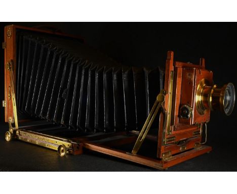 A large early 20th century lacquered brass and mahogany plate camera, "Triple Victo" by Thornton Pickard, with a Beck Symmetr