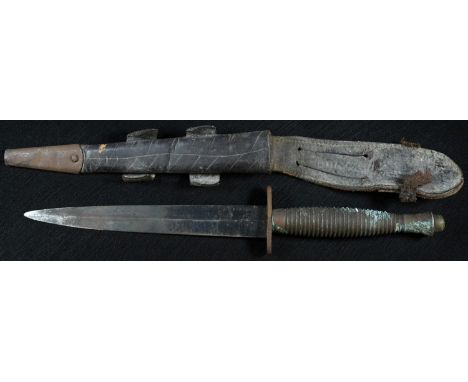 A Fairbairn?Sykes fighting knife, second pattern, 17.5cm blade, ribbed grip, 29.5cm long overall, leather scabbard 