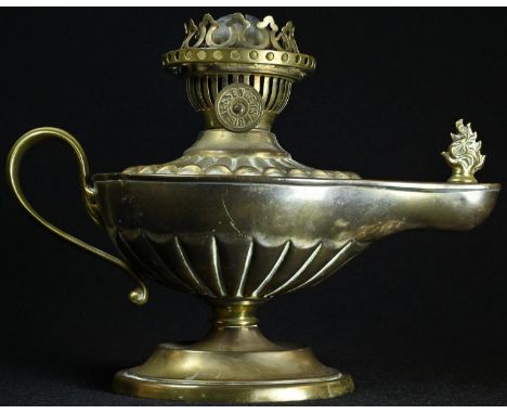 An Edwardian brass study oil lamp, in the Neo-Classical taste as a Roman lamp, embossed with batwing flutes, adjustable burne