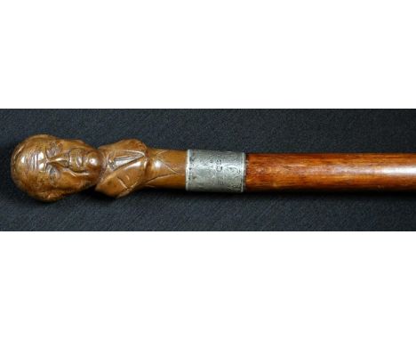 A gentleman's novelty walking cane, the pommel carved as a portrait bust of David Lloyd George, silver ferrule, hardwood shaf