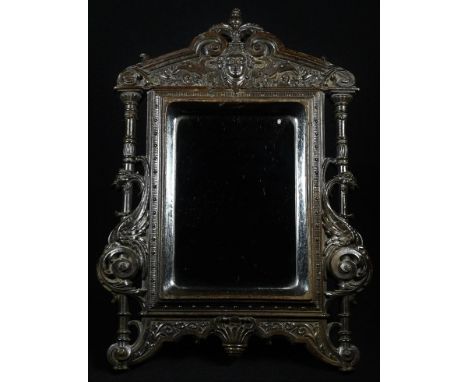 A 19th century Renaissance Revival bois durci easel looking glass, rectangular mirror plate, the architectural frame moulded 