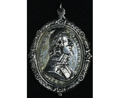 King Charles the Martyr - a silver coloured metal commemorative pendant medallion, in relief with a profile portrait of Charl