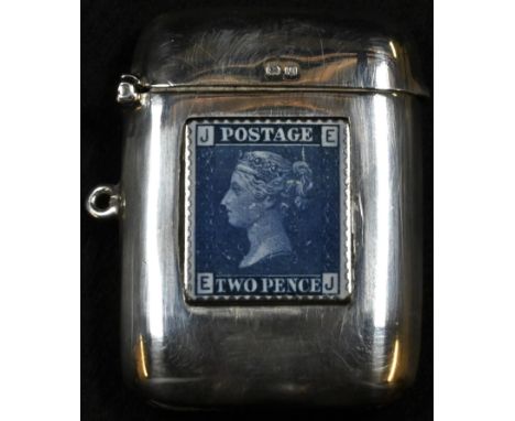 A George V silver rounded rectangular vesta case, hinged cover, later applied to recto with an enamel depiction of a Victoria