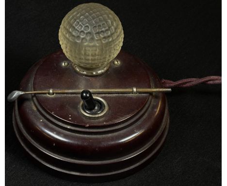 Golf - a Stesco bakelite novelty bedside table lamp, the frosted glass globe as a golf ball, a club laid across, 10.5cm diam,