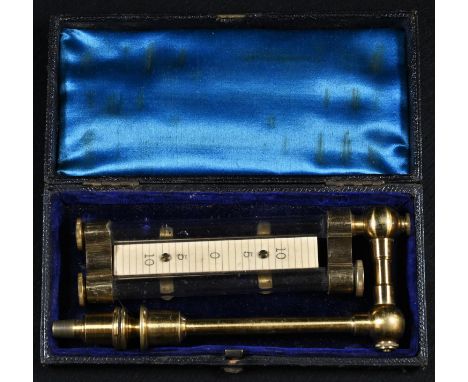 A 19th/early 20th century lacquered brass scientific instrument or measure, the ivorine scale marked out 10-5-0-5-10 and flan