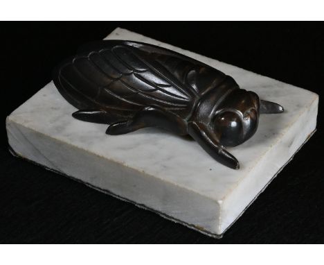 A dark patinated bronze novelty desk weight, cast as an oversized insect, 11cm wide 