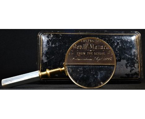 A late 19th century gilt brass connoisseur's hand lens, the magnifying glass with mother of pearl haft, 19cm long overall, fi