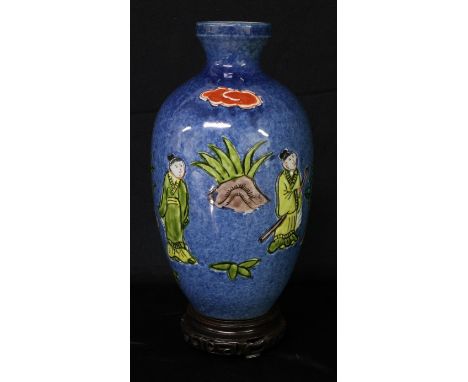 A Chinese ovoid vase, painted in polychrome with figures holding a scroll, beneath a banner inscribed with verse, 23cm high, 