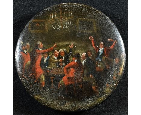 A George III papier mache circular snuff box, the slightly domed cover painted with huntsmen at dinner, in pinks, toasting th