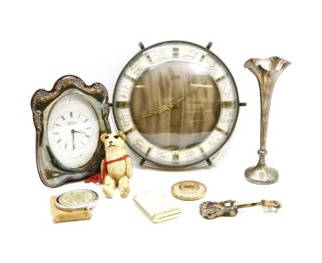 A modern silver framed mantel clock, silver specimen vase, three compacts, tiny teddy, tortoiseshell guitar, and Schatz Zodia