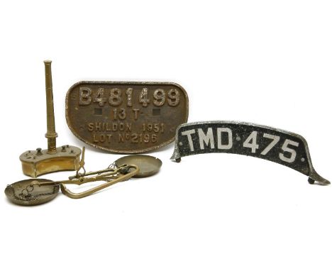 A cast iron steam train no. plate, a vintage vehicle no. plate, and a set of old brass scales and weights