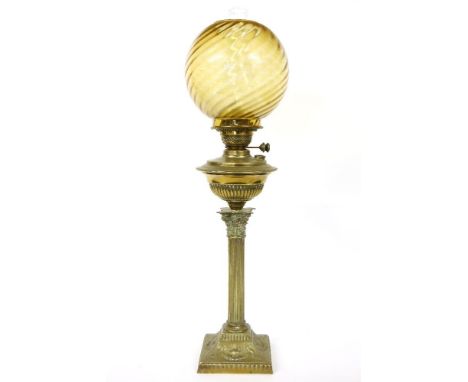 A Victorian brass oil lamp, the amber glass spherical shade on Corinthian column base, 77cm high