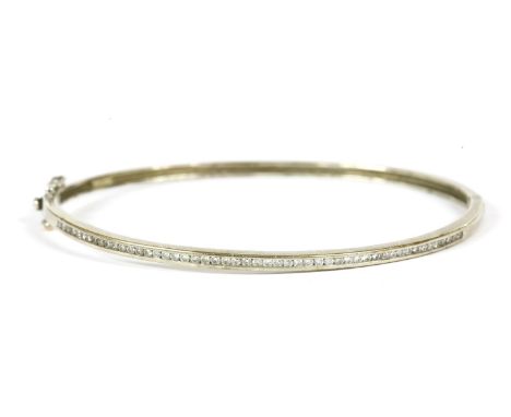A 9ct white gold channel set brilliant cut diamond set half hoop hinge bangle,8.08g
