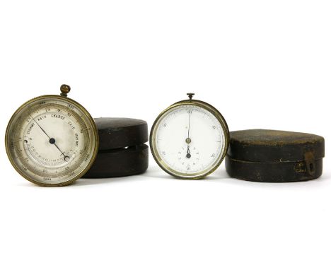 A lacquered brass pocket barometer,together witha similar stopwatch both in fitted cases (2)