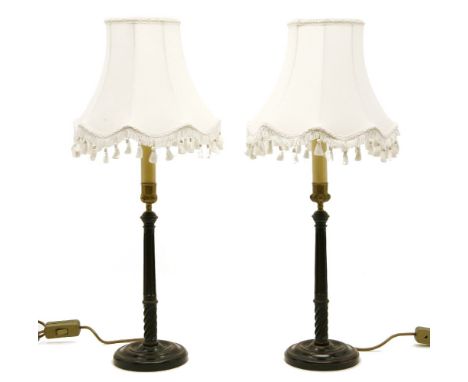 A pair of carved fluted wooden candlestick table lamps, and shades