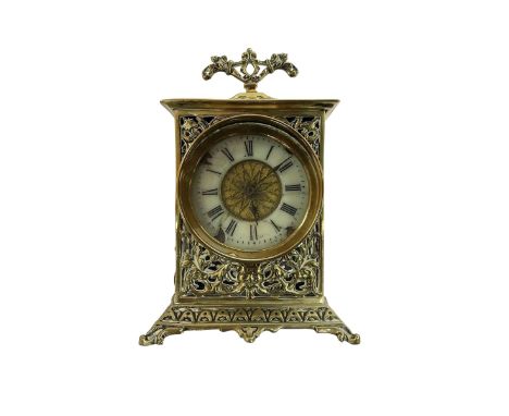 Small bedside table clock in a pierced brass case on a splayed plinth, with a 30hr spring wound movement with a balance escap