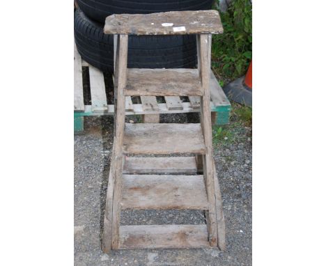 A vintage 4 rung wooden step ladder.