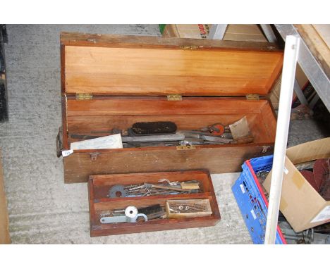 A long wooden carpenters tool box with tools.